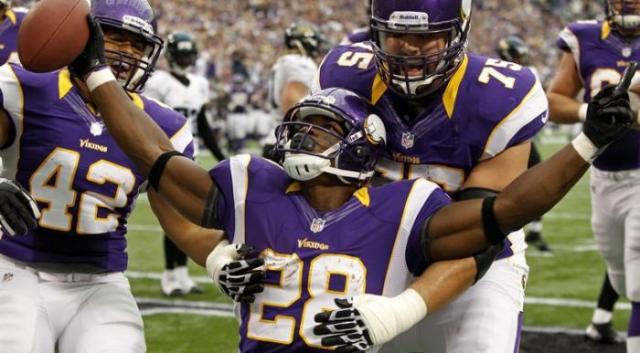 Adrian Peterson celebrates a touchdown. If you land him in your draft, you should celebrate too.